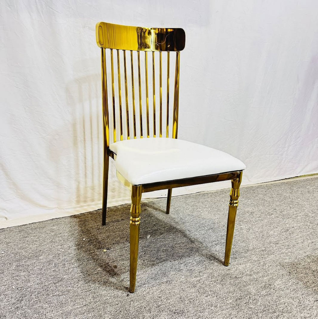 Elegant event setup featuring gold stainless steel wedding chairs with vertical stripes backrests