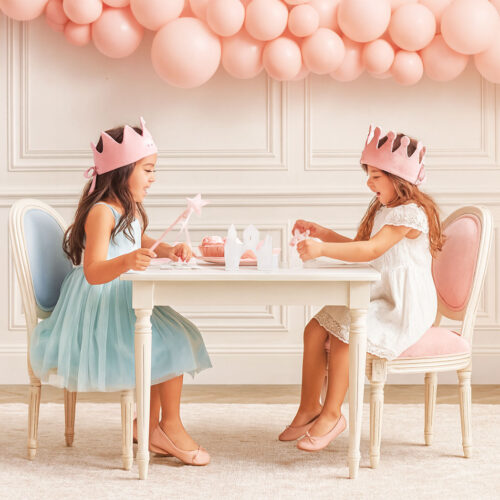 Kids Louis Chairs with pastel pink and blue fabric used in an elegant children’s party setup with balloons and table décor.