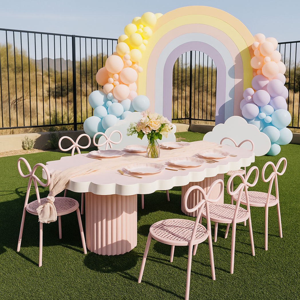 On-site kids birthday party setup with white scallop-edge cloud table and pastel decorations