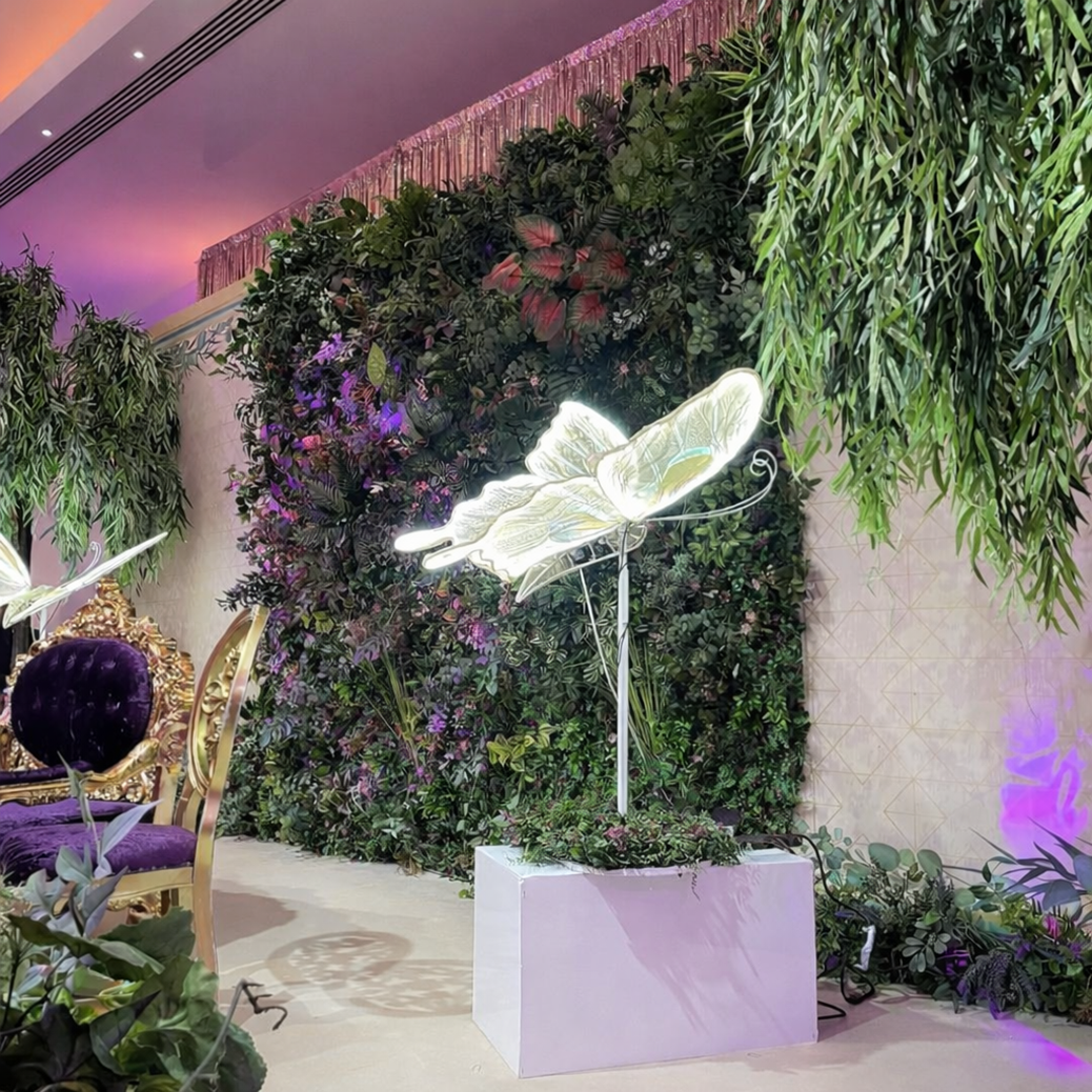Decorative lighting detail with green wall wedding backdrop in London