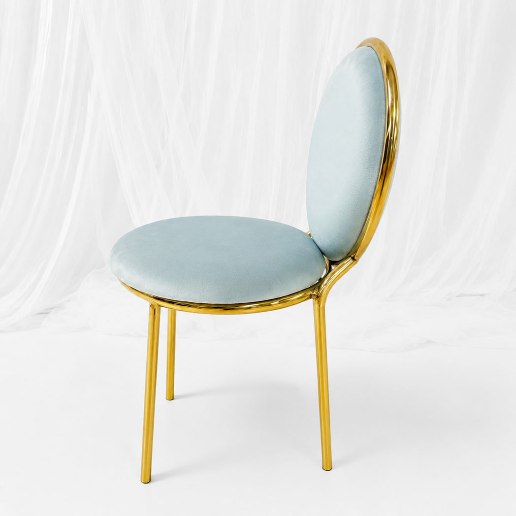 Side view of kids round back event chair with mirror gold stainless steel frame and light blue velvet upholstery
