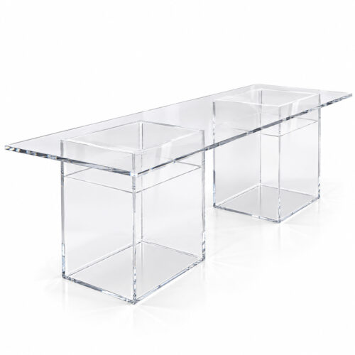 Clear acrylic kids party table with a rectangular transparent tabletop and two hollow box-shaped pedestal bases, shown from a front three-quarter angle on a white background.